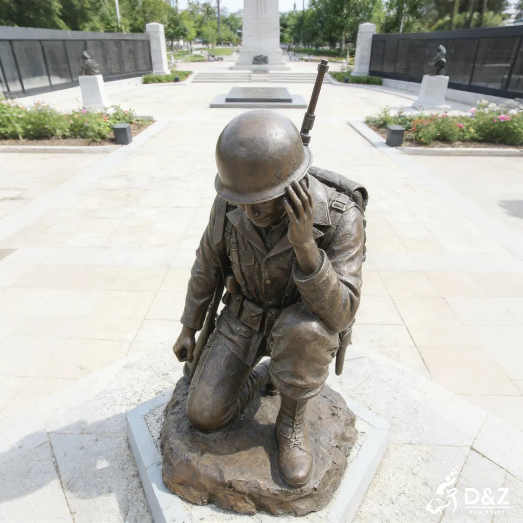 Overhead view of a bronze kneeling soldier statue in a memorial park